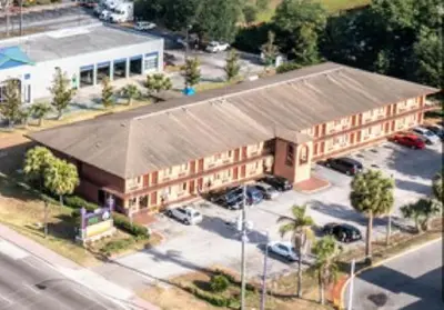 an overhead view of a large building with a parking lot at Oak Ridge Inn in Kissimmee