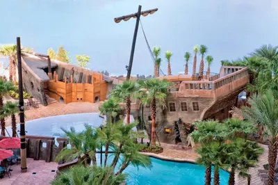 a resort with a swimming pool and palm trees at Wyndham Bonnet Creek 1BR Apartment with Resort Access in Orlando