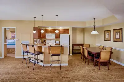 a kitchen and dining room with a table and chairs at Wyndham Bonnet Creek 1BR Apartment with Resort Access in Orlando