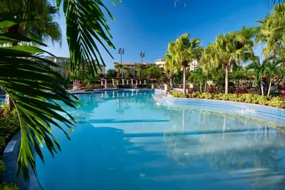 a large pool with palm trees in a resort at Wyndham Bonnet Creek 1BR Apartment with Resort Access in Orlando