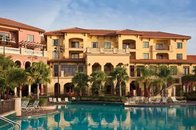 a hotel with a swimming pool in front of a building at Wyndham Bonnet Creek 2BR Apartment with Resort Access in Orlando