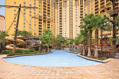 a water park in a city with palm trees and buildings at Wyndham Bonnet Creek 3BR Apartment with Resort Access in Orlando