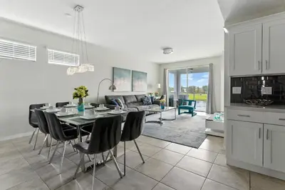 a kitchen and dining room with a table and chairs at Beautiful Lakeview Retreat Near Disney in Kissimmee