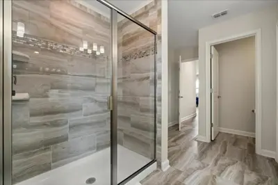 a walk in shower with a glass door in a bathroom at 6 Bedrooms 5 Bathrooms Storey Lake 4763Kc in Kissimmee