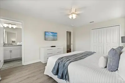 a white bedroom with a bed and a ceiling fan at 6 Bedrooms 5 Bathrooms Storey Lake 4763Kc in Kissimmee