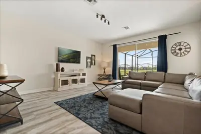 a living room with a couch and a large window at 6 Bedrooms 5 Bathrooms Storey Lake 4763Kc in Kissimmee
