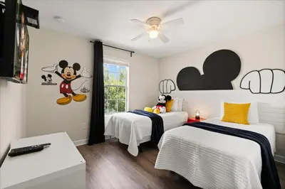 a bedroom with two beds and a mickey mouse mural at 6 Bedrooms 5 Bathrooms Storey Lake 4763Kc in Kissimmee