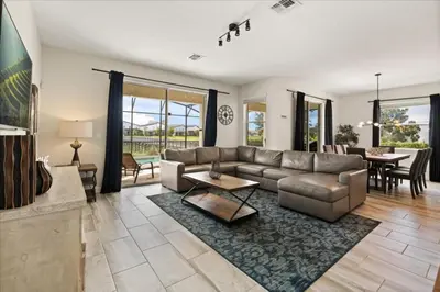 a living room with a couch and a table at 6 Bedrooms 5 Bathrooms Storey Lake 4763Kc in Kissimmee