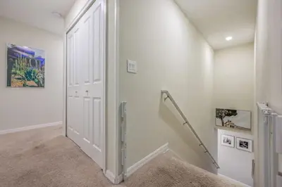 a white hallway with a white door and stairs at Casa 4 Quartos c/ Piscina – 10 Min da Disney in Kissimmee