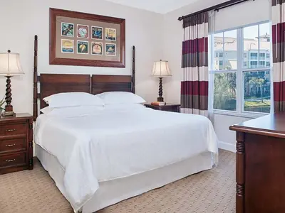 a bedroom with a large white bed and a window at Sheraton Vistana Villages 2BR Apartment with Resort Access in Orlando