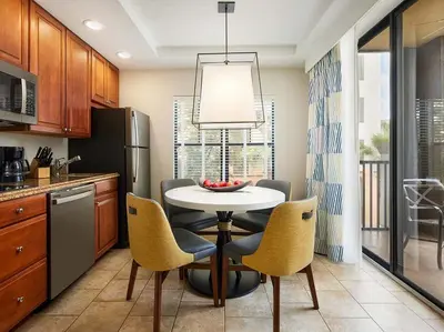 a kitchen with a table and chairs and a refrigerator at Sheraton Vistana Villages 2BR Apartment with Resort Access in Orlando