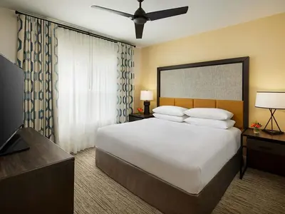 a bedroom with a large white bed and a television at Sheraton Vistana Villages 3BR Apartment with Resort Access in Orlando