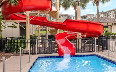 a red slide in a pool at a resort at Sheraton Vistana Villages 3BR Apartment with Resort Access in Orlando