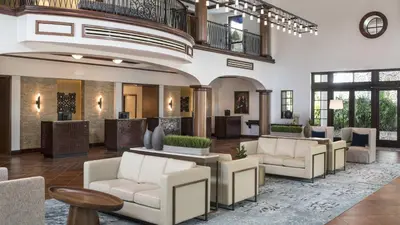 a lobby with white couches and tables at Marriott's Lakeshore Reserve Studio Apartment with Resort Access in Orlando