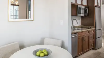 a kitchen with a white table and a bowl of fruit at Marriott's Lakeshore Reserve Studio Apartment with Resort Access in Orlando