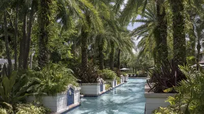 a canal with palm trees and plants in a resort at Marriott's Lakeshore Reserve Studio Apartment with Resort Access in Orlando