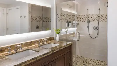 a bathroom with two sinks and a shower at Marriott's Lakeshore Reserve 1BR Apartment with Resort Access in Orlando