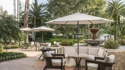 a patio with tables and chairs and a fountain at Marriott's Lakeshore Reserve 2BR Villa with Resort Access in Orlando
