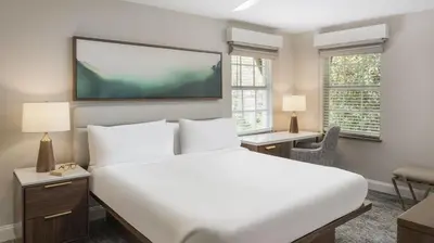 a bedroom with a large bed and a flat screen tv at Marriott's Lakeshore Reserve 2BR Villa with Resort Access in Orlando