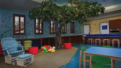 a room with a tree and a table and chairs at Marriott's Lakeshore Reserve 2BR Villa with Resort Access in Orlando