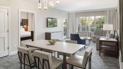 a dining room and living room with a table and chairs at Marriott's Lakeshore Reserve 3BR Apartment with Resort Access in Orlando
