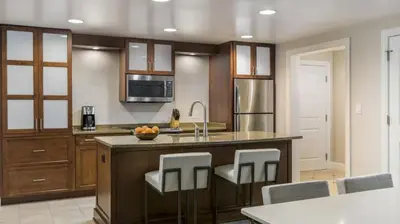 a kitchen with a large island with bar stools at Marriott's Lakeshore Reserve 3BR Apartment with Resort Access in Orlando