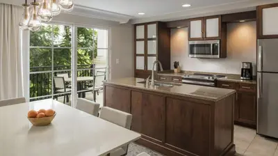 a kitchen with a table with a bowl of fruit on it at Marriott's Lakeshore Reserve 3BR Apartment with Resort Access in Orlando