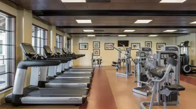 a gym with rows of treadmills and ellipticals at Marriott's Lakeshore Reserve 3BR Apartment with Resort Access in Orlando
