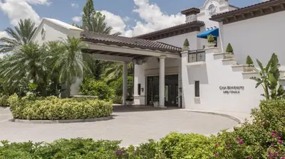 a white house with a porch and a driveway at Marriott's Lakeshore Reserve 3BR Apartment with Resort Access in Orlando