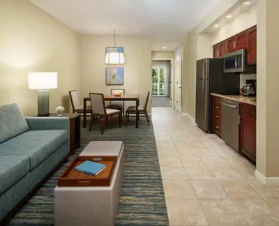 a living room with a couch and a table and a kitchen at Sheraton Vistana Resort One Bedroom Apartment in Orlando