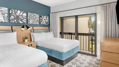 a hotel room with two beds and a balcony at Marriott's Sabal Palms 2BR Apartment with Resort Access in Orlando