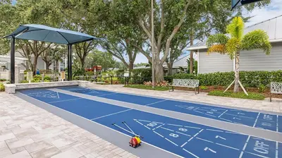 a blue tennis court with an umbrella on it at Marriott's Cypress Harbour 2BR Apartment with Resort Access in Orlando
