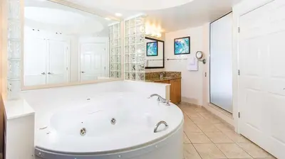 a large white bathroom with a tub and a sink at Marriott's Cypress Harbour 2BR Apartment with Resort Access in Orlando