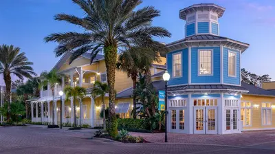 a large house with a palm tree in front of it at Marriott's Harbour Lake 1BR Apartment with Resort Access in Orlando