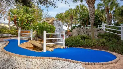 a playground with a slide on a blue ground at Marriott's Harbour Lake 1BR Apartment with Resort Access in Orlando