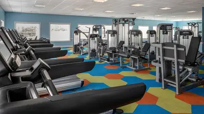 a gym with rows of tread machines on a colorful carpet at Marriott's Harbour Lake 2BR Apartment with Resort Access in Orlando
