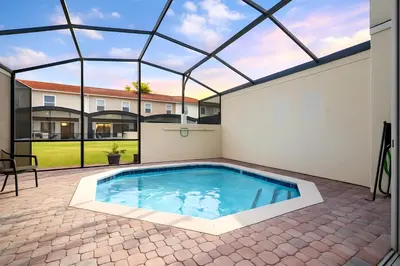 an indoor swimming pool in a house with a glass roof at Charming 3BR Resort Townhome with Private Pool near Disney in Kissimmee