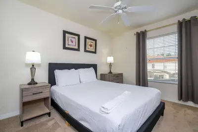 a bedroom with a bed and a ceiling fan at Charming 3BR Resort Townhome with Private Pool near Disney in Kissimmee