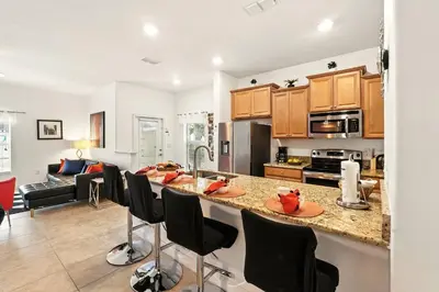 a kitchen and living room with a large counter top at Vibrant 5BR Family Retreat in Storey Lake in Kissimmee