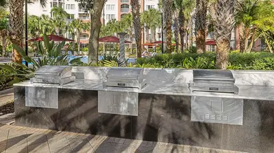 a stainless steel bench in a park with palm trees at Marriott's Grande Vista Studio Apartment with Resort Access in Orlando