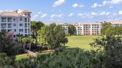 a view of a golf course with buildings and trees at Marriott's Grande Vista 1BR Apartment with Resort Access in Orlando