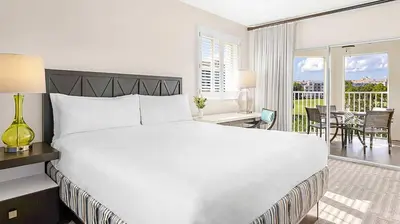 a white bedroom with a large bed and a balcony at Marriott's Grande Vista 3BR Apartment with Resort Access in Orlando