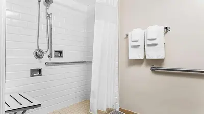 a bathroom with a shower and a toilet and towels at Marriott's Grande Vista 3BR Apartment with Resort Access in Orlando