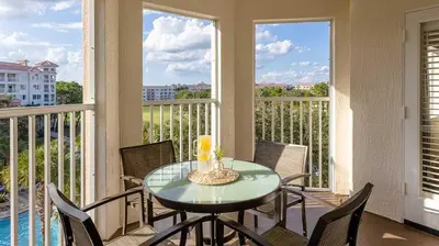a dining room with a table and chairs and windows at Marriott's Grande Vista 3BR Apartment with Resort Access in Orlando