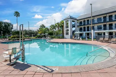 a large swimming pool in front of a building at voco Kissimmee Orlando by IHG in Orlando