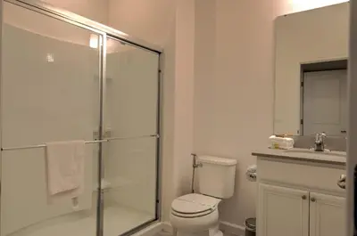 a bathroom with a shower and a toilet and a sink at 10461 Amazing 5BD Family Townhouse at Paradiso Grande in Orlando