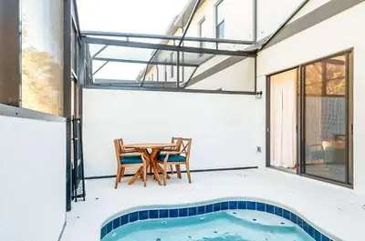 a house with a swimming pool and a table at 10461 Amazing 5BD Family Townhouse at Paradiso Grande in Orlando