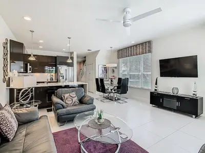 a living room with a couch and a table at Harmony in Orlando