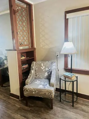 a living room with a chair and a lamp at Spacious Lake Retreat for Families in Saint Cloud