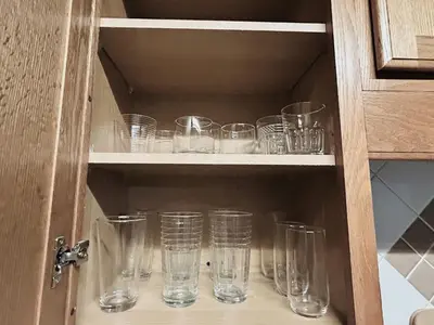 a cupboard filled with empty glasses sitting at Spacious Lake Retreat for Families in Saint Cloud